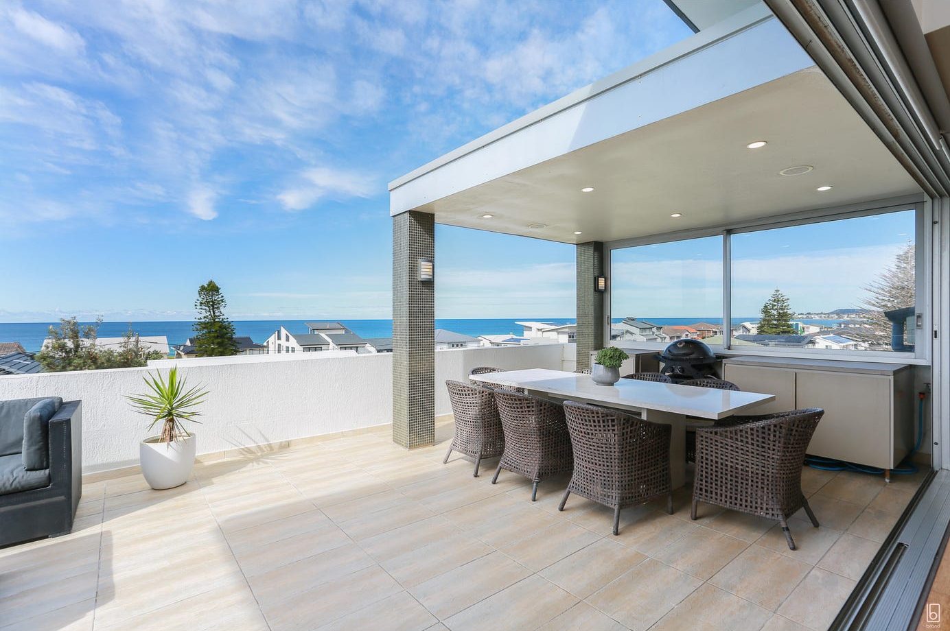 Rooftop terrace with outdoor dining and ocean views